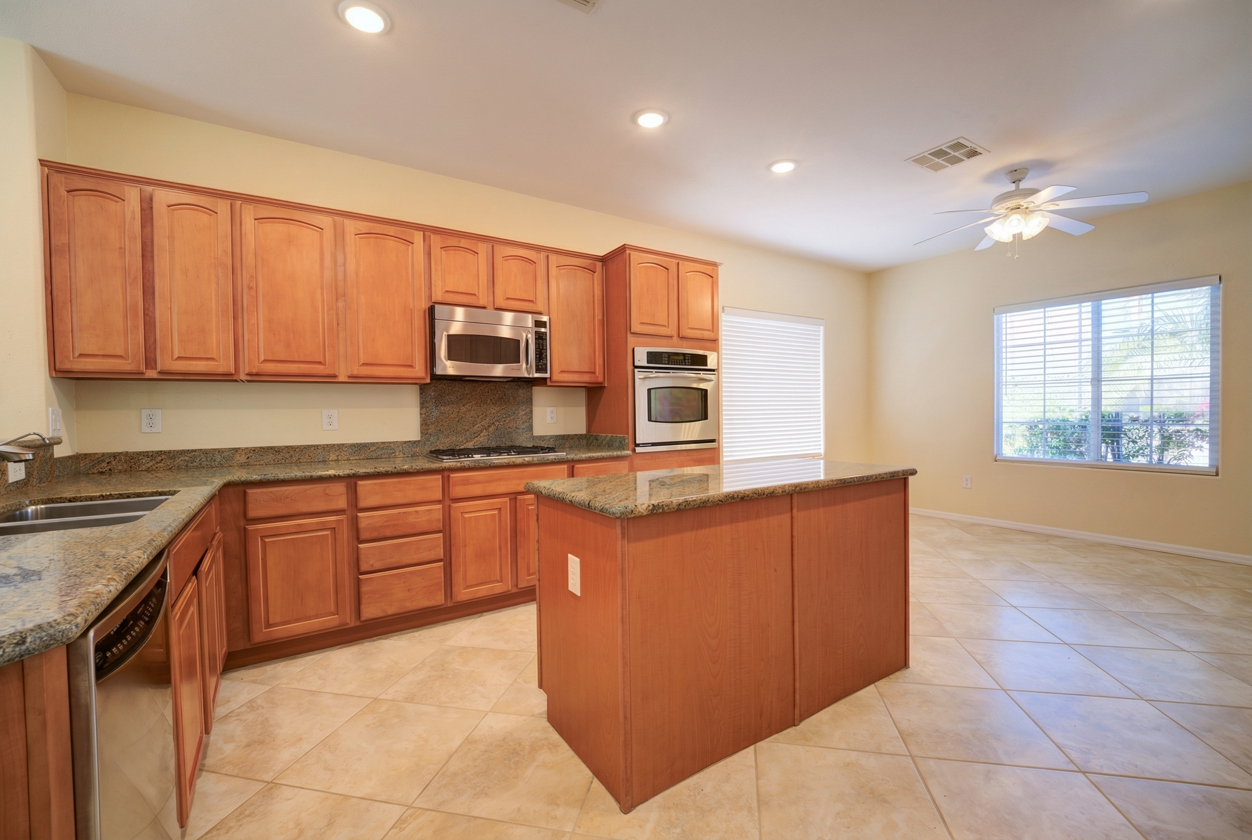 Kitchen with light-wood cabinetry and granite