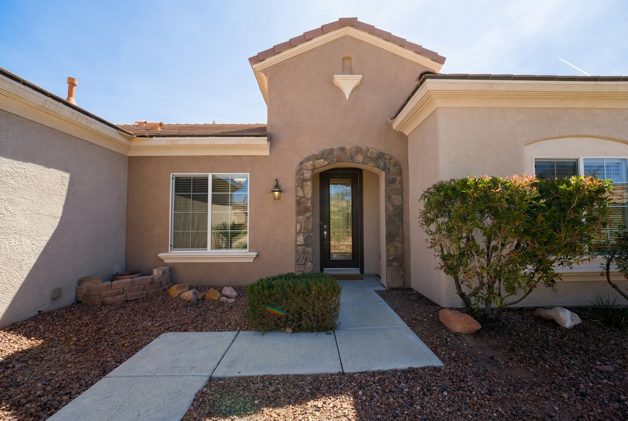 Front entrance with palms and stucco